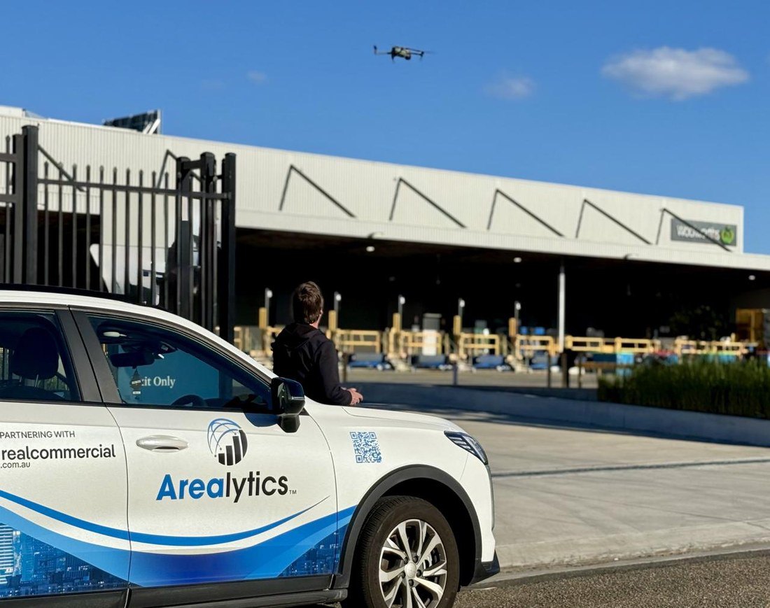 Arealytics field research — branded vehicle and drone on site